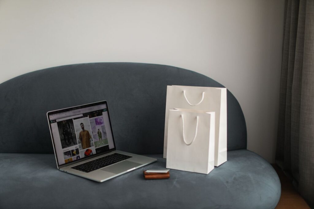Crafting Captivating Headlines: Your awesome post title goes here Online shopping setup with a laptop and shopping bags on a stylish couch.
