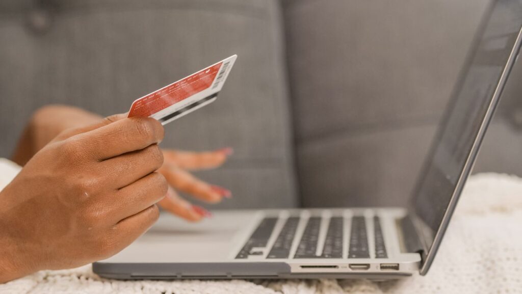 Mastering the First Impression: Your intriguing post title goes here Close-up of a person using a credit card for online shopping on a laptop.